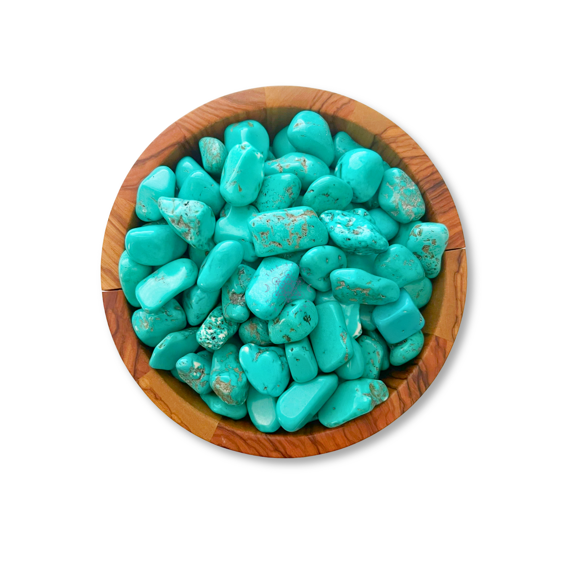 A wooden bowl filled with numerous polished Turquoise Howlite Tumbled Stones. The stones are smooth, varying in size and shape, with some showing marbled patterns of brown veins. Known to aid the throat chakra and reduce anxiety, this collection sits against a plain white background.