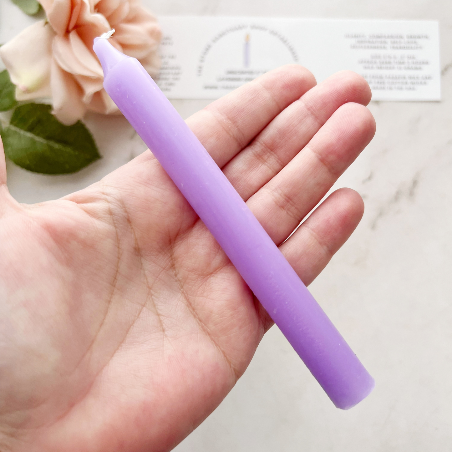 A bundle of five 5" Lavender Chime Candles, neatly aligned and tied together with a black string, rests on a white wooden background. The chime candles boast a smooth, slightly matte finish perfect for chakra balancing rituals.