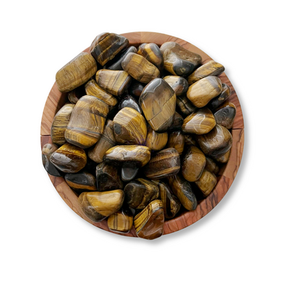 A wooden bowl filled with Tigers Eye Tumbled Stones, displaying their characteristic golden-brown and black bands, radiates grounding energy and a protective aura against a white background.