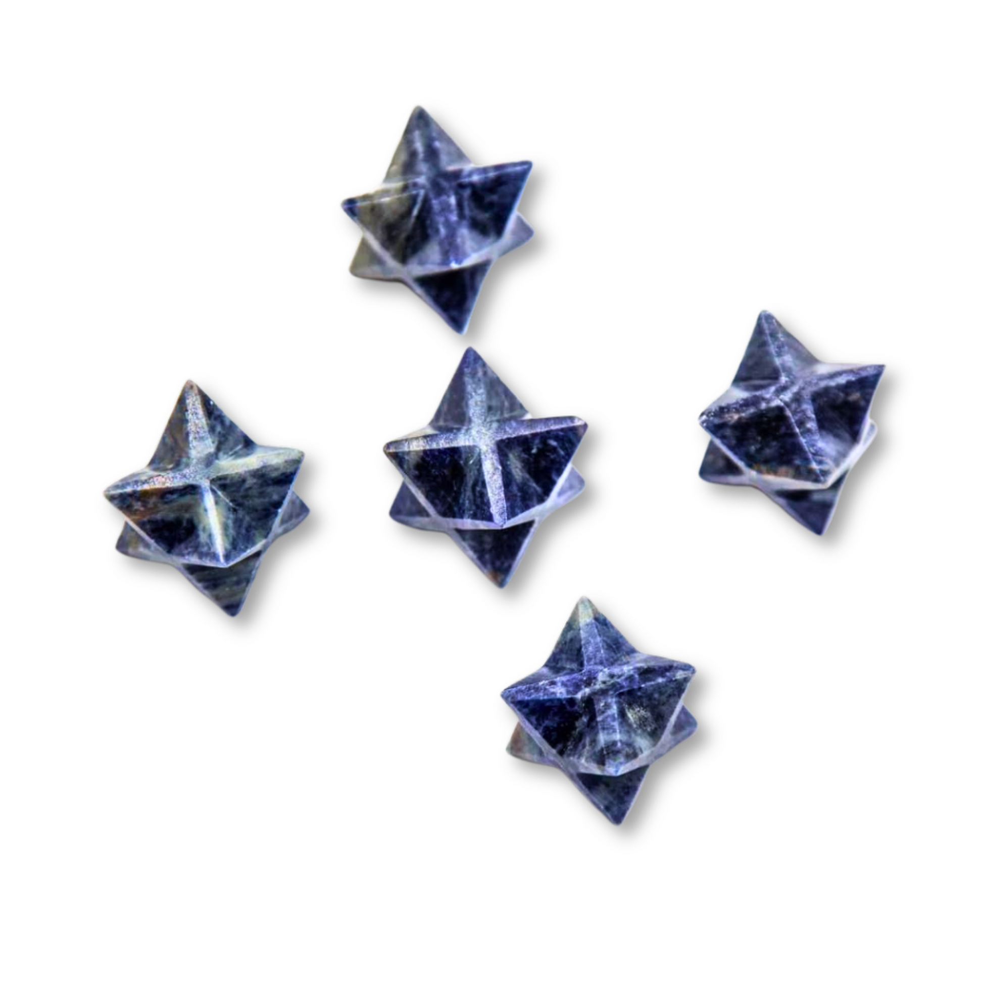 Five small, star-shaped objects made of a dark blue and black marbled material, arranged randomly against a plain white background. Each Mini Sodalite Merkaba has a three-dimensional form with pointed edges, reminiscent of Sodalite Merkaba symbols that enhance spiritual evolution and serve as stones of insight.