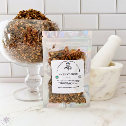 A pack of Angelica Root from "The Forest Sanctuary," used for spiritual rituals, is displayed in front of a mortar and pestle on a white counter. A glass bowl filled with the same herbs sits next to it, against a backdrop of white subway tiles.