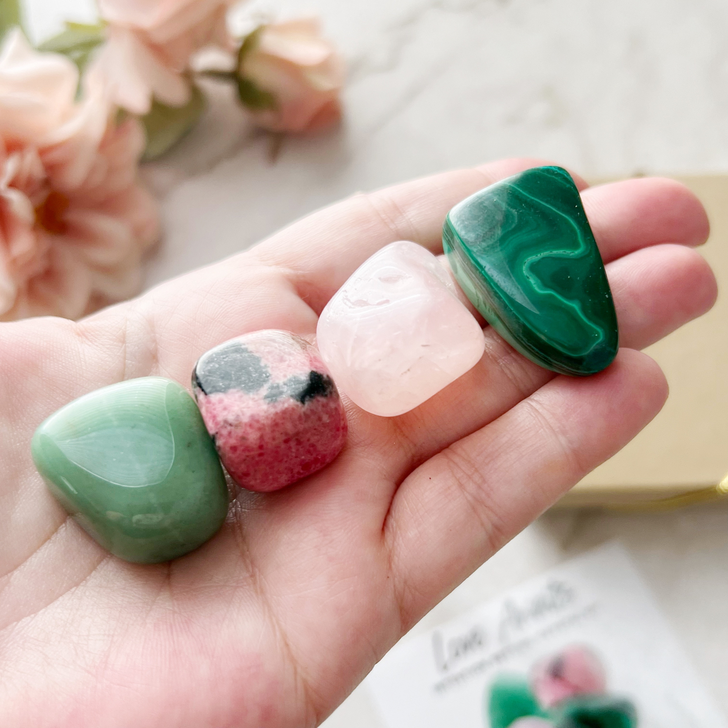 Introducing the "Love Awaits Crystal Kit," an intention-setting collection featuring four polished stones: green aventurine, rhodonite, rose quartz, and malachite. These manifestation crystals bring positive energies for attracting new opportunities, emotional healing, and manifesting love.