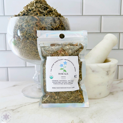 A clear plastic bag labeled "Borage Herb" containing dried leaves is displayed in the foreground. Behind it, there's a glass bowl filled with dried leaves and a white marble mortar and pestle set. The background features a white tiled wall, reminiscent of spiritual rituals involving Borage Herb.