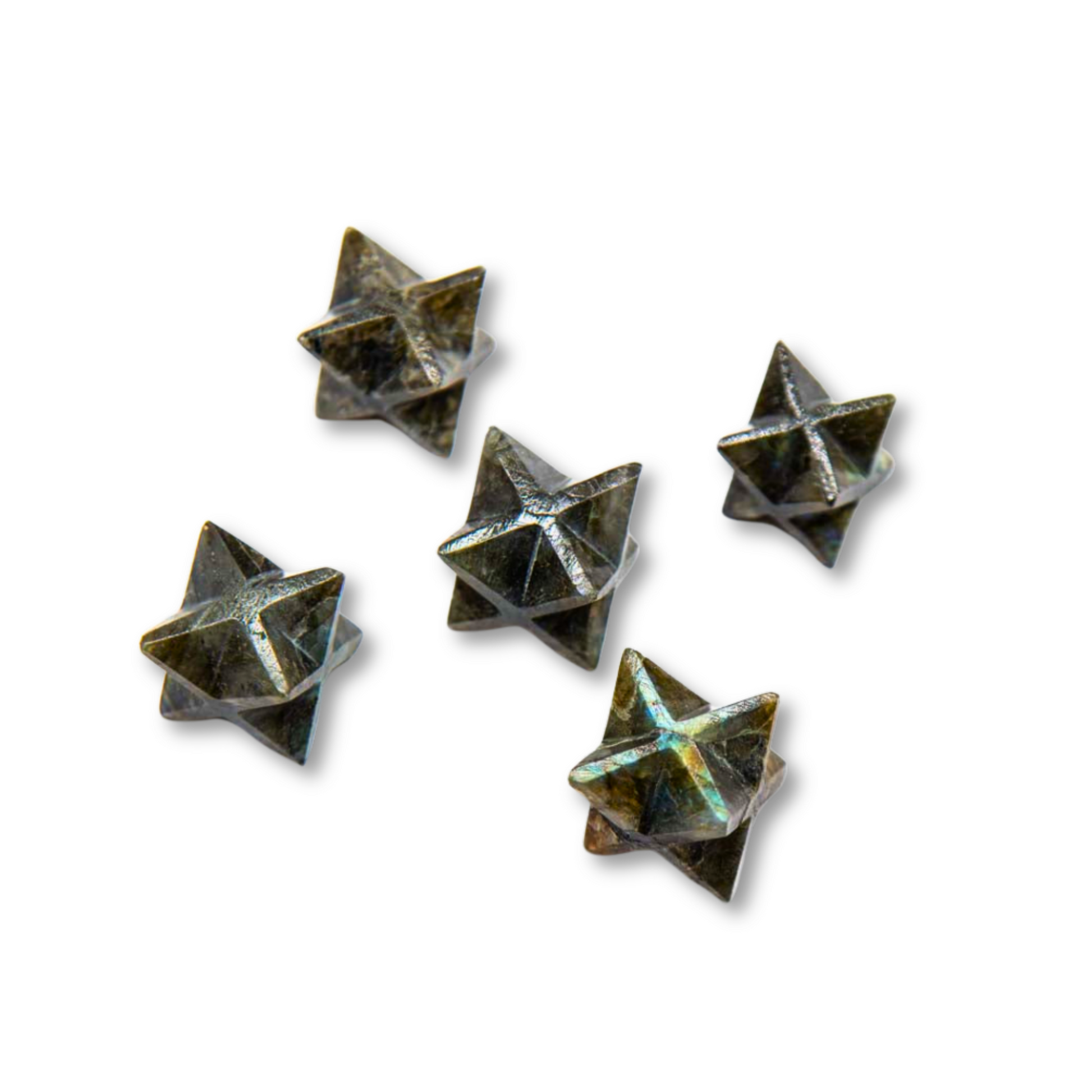 Five Mini Labradorite Merkaba objects are arranged casually on a white background. Each star has pyramidal points extending from its center, creating a multifaceted appearance that could inspire thoughts of spiritual growth.