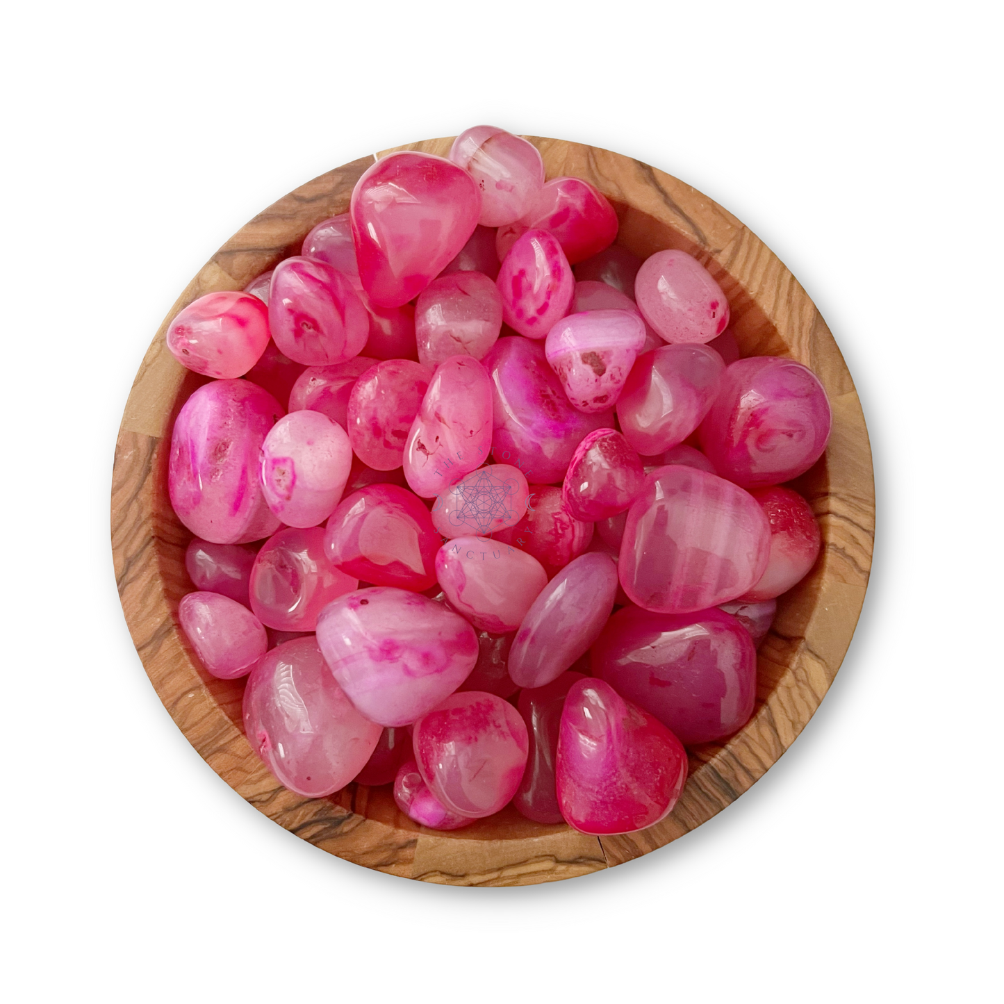 A wooden bowl filled with smooth, polished Pink Onyx Tumbled Stones of varying sizes and shades. The stones have a glossy finish and some exhibit white marbling, offering a mix of vibrant and subtle pink hues. The background is white, making the colors pop.