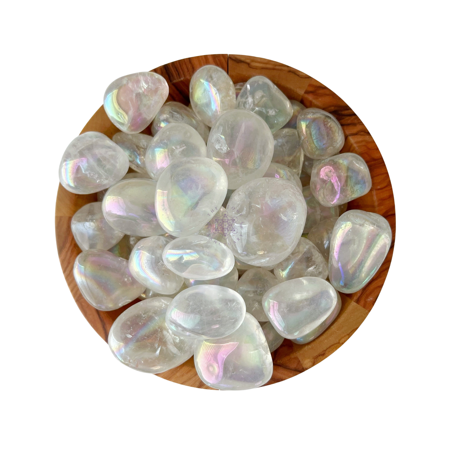 A wooden bowl filled with smooth, translucent Angel Aura Quartz Tumbled Stones displays a range of light rainbow hues, giving them a luminous and ethereal appearance. Known as a high vibrational stone, they are said to promote emotional stability.