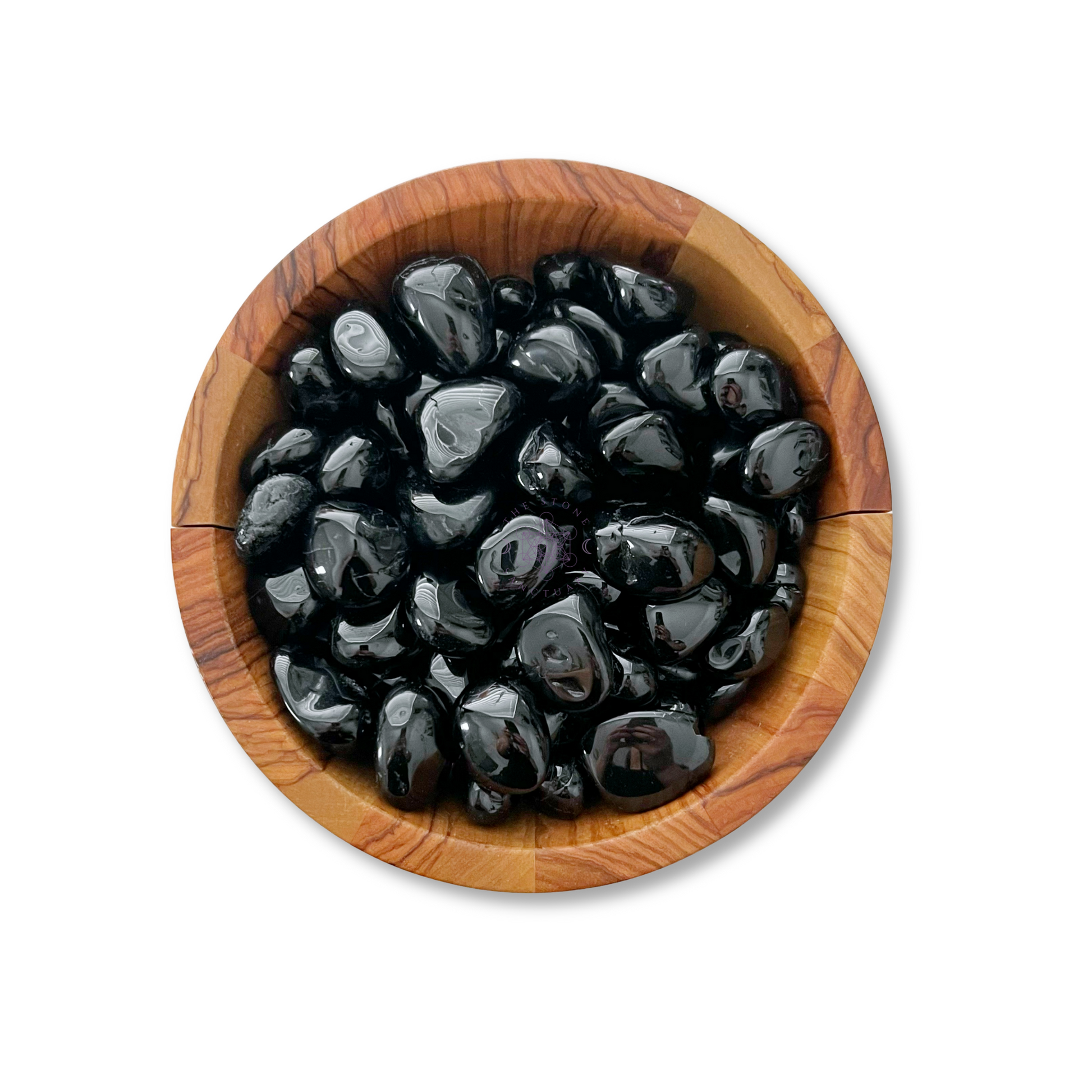 A wooden bowl filled with shiny Black Spinel Tumbled Stones on a plain white background. The stones are glossy and closely packed, showing their smooth, dark surface like Black Spinel gemstones. The bowl's wooden texture contrasts with the glossy appearance of the Black Spinel Tumbled Stones.