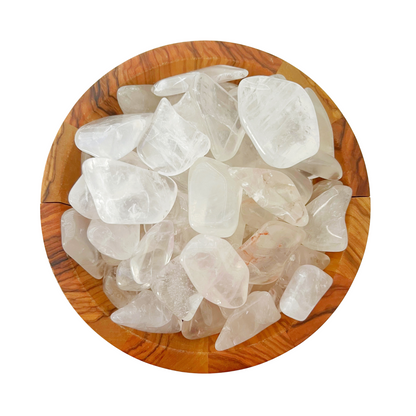 A round wooden bowl filled with smooth, transparent, irregular-shaped Girasol Quartz Tumbled Stones. These clear gems, possessing a subtle cloudy texture, are known for their emotional healing properties and are beautifully placed against a white background.