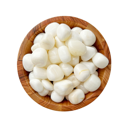 A wooden bowl filled with White Calcite Tumbled Stones. The stones, smooth and white like peeled garlic cloves, are tightly packed together, while the rustic wooden bowl showcases visible grain patterns. Against a plain white background, the scene almost evokes the metaphysical properties of white calcite.