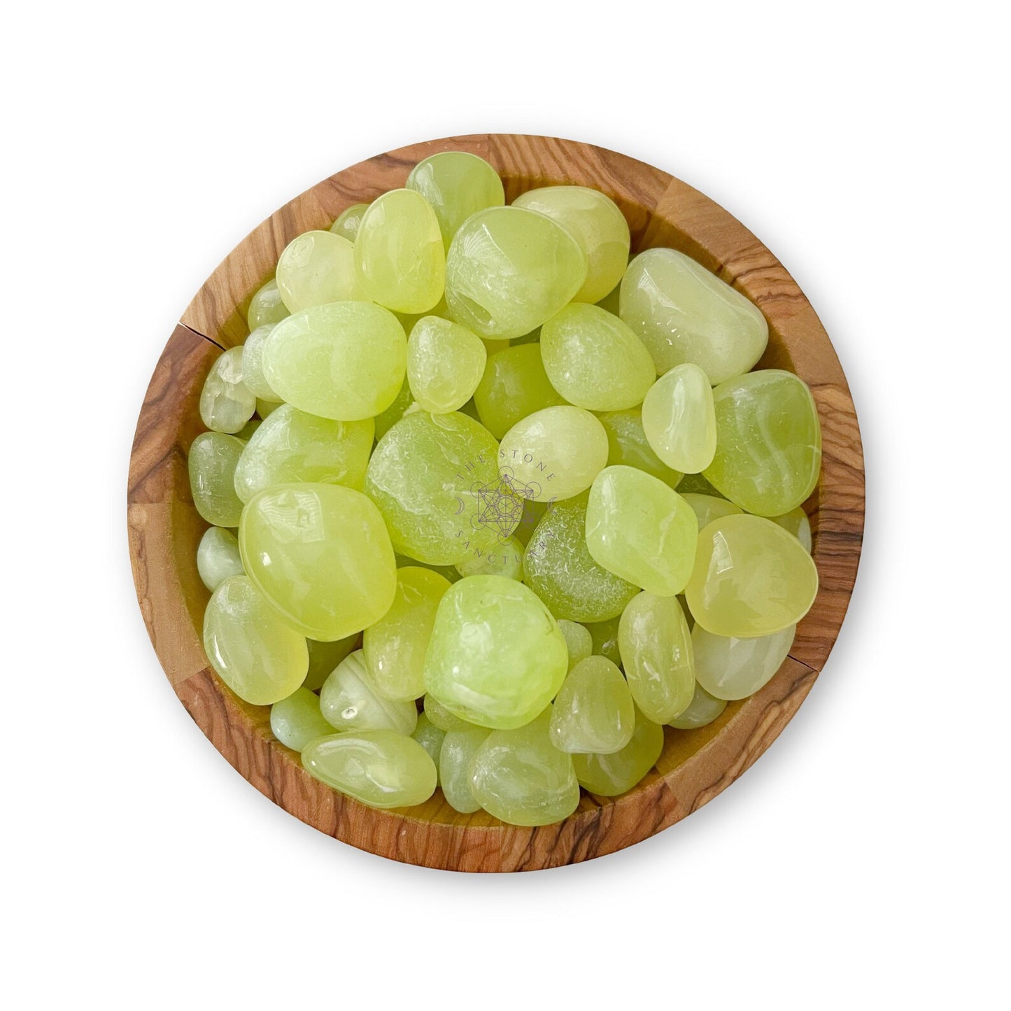 A wooden bowl filled with an assortment of polished, light green stones, including Parrot Green Onyx Tumbled Stones for anxiety relief, arranged on a white background. The stones have a smooth, shiny surface and varying sizes.