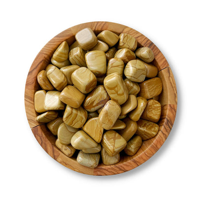 A wooden bowl filled with polished, light brown Brown Walnut Jasper Tumbled Stones with natural patterns and variations. The grounding stones are smooth and rounded, creating a visually appealing and uniform texture within the bowl. The white background highlights the bowl and its contents perfectly.