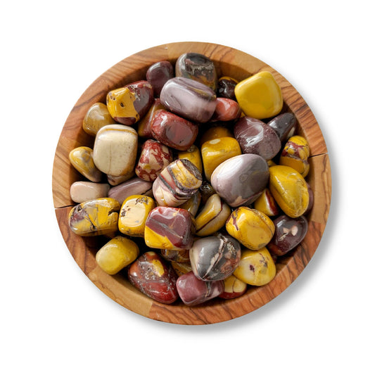 A wooden bowl filled with polished, multicolored stones, including Mookaite Tumbled Stones. The stones vary in colors such as shades of yellow, brown, red, and gray. The bowl and stones are placed on a white background.