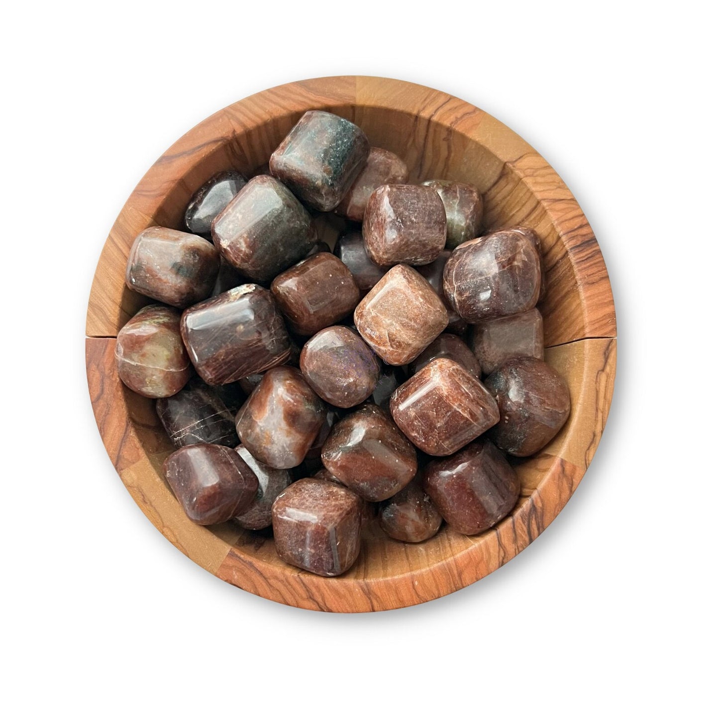 A wooden bowl filled with polished, rounded Hessonite Garnet Tumbled Stones of varying sizes. Predominantly brown with hints of green and red, the stones have a glossy finish. Among them, you can spot the rich hues of Cinnamon Stone and Hessonite Garnet, all set against a white background.