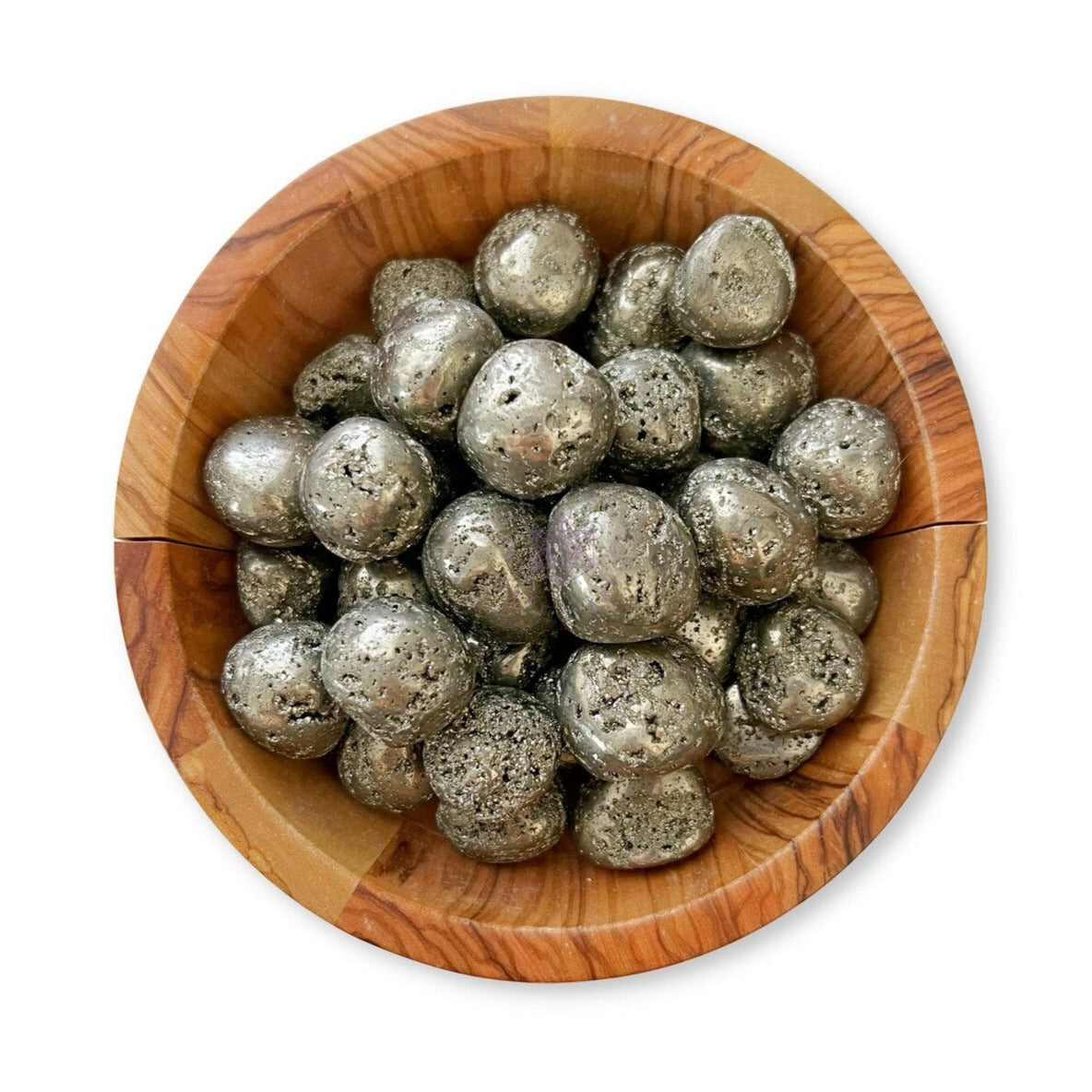 A wooden bowl filled with metallic, spherical stones, which have a rough, slightly porous texture. The stones are shiny, with a silver-like color and some irregularities, giving them a naturally rugged appearance. Among them are Pyrite Tumbled Stones known as protection stones.