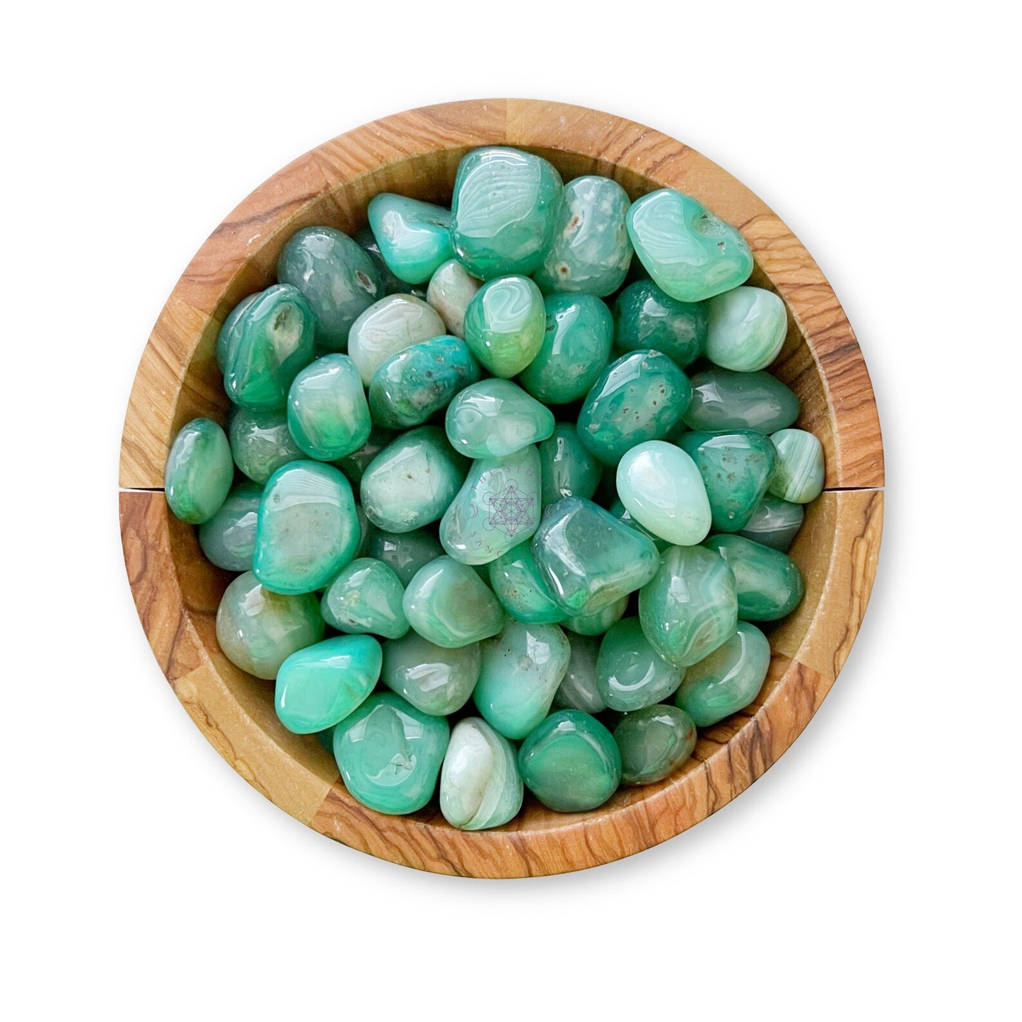 A wooden bowl filled with Green Agate Tumbled Stones of various shapes and sizes. The stones have a glossy finish and a range of green shades, creating a visually appealing and natural balance. The bowl is positioned centrally on a white background.