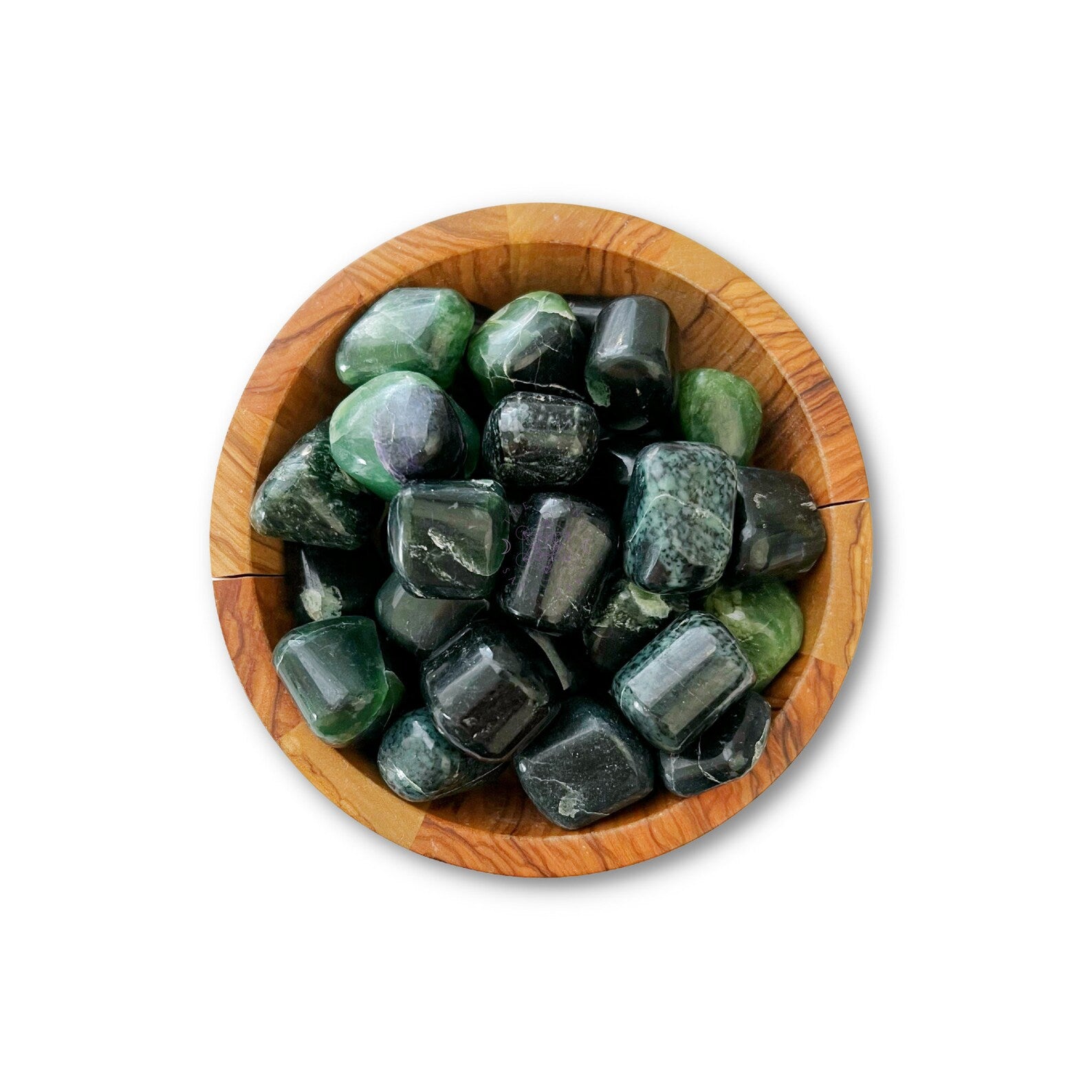 A wooden bowl filled with smooth, polished Green Kyanite Tumbled Stones, perfect for chakra alignment. The stones have a glossy finish and are irregular in shape, fitting snugly within the bowl. The background is plain white.