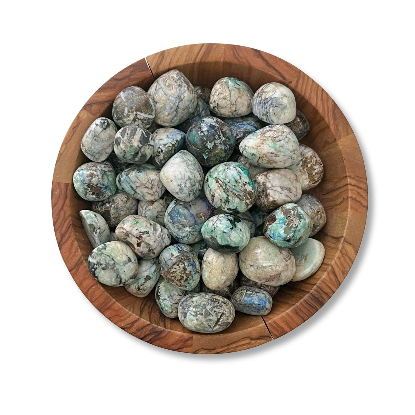 A wooden bowl filled with Azurite Malachite Tumbled Stones, each featuring a mix of green, blue, white, and brown hues. The stones have a smooth, rounded appearance and the bowl is placed on a white background.