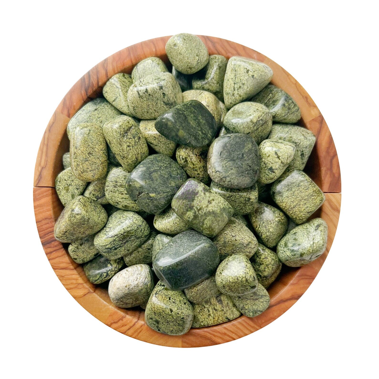 A wooden bowl filled with polished, green Asterite Serpentine Tumbled Stones. The stones, known for their connection to the Heart Chakra and Root Chakra, vary slightly in shade and texture, giving them a natural, earthy appearance. The bowl sits on a plain white background, highlighting the colors and details of these healing gemstones.