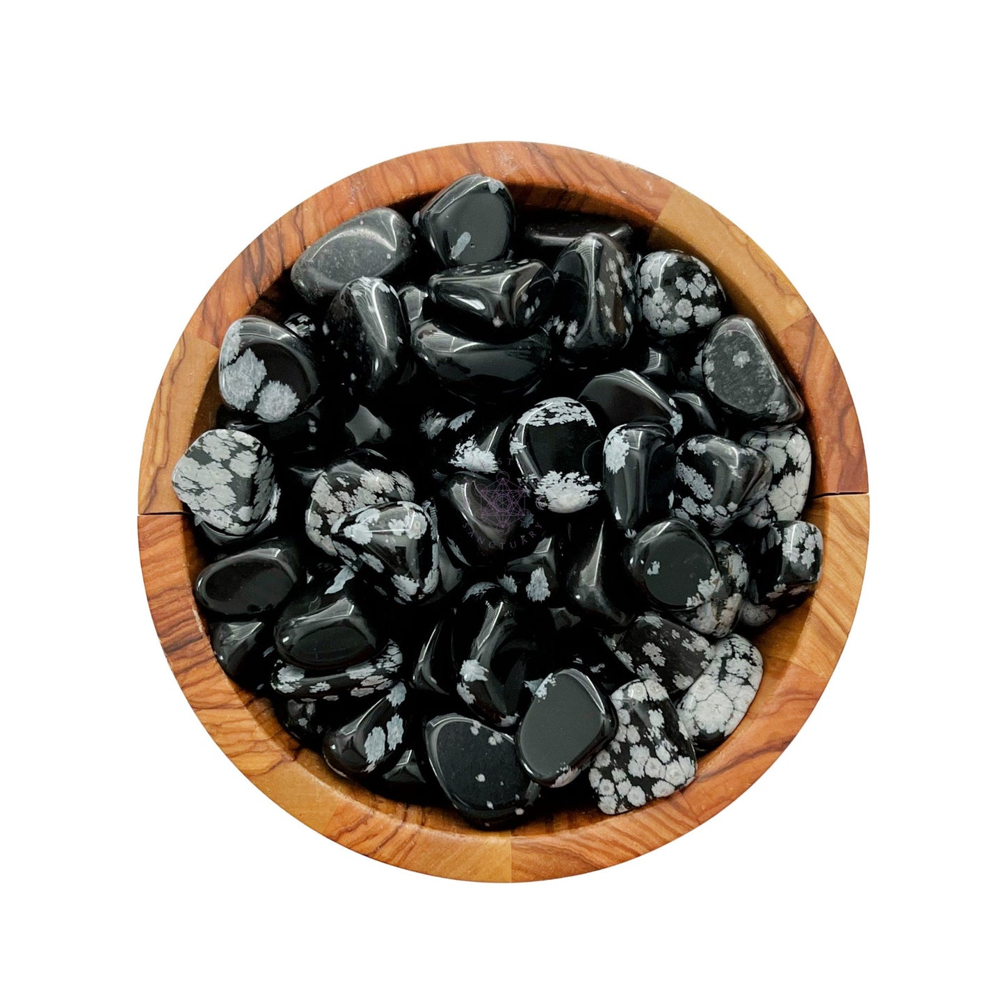 A wooden bowl filled with polished, black and white speckled Snowflake Obsidian Tumbled Stones. The glossy finish of these healing stones highlights their unique patterns and textures, compactly arranged within the bowl to promote balance of body, mind, and spirit.