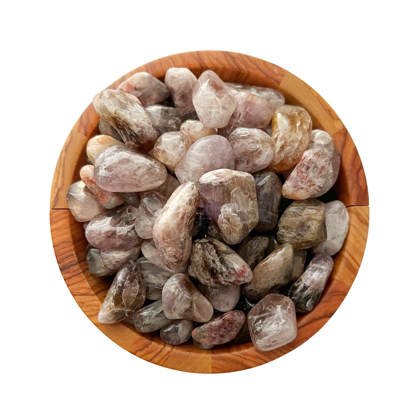 A collection of Super Seven Tumbled Stones in various shades of pink and gray are piled in a wooden bowl. The bowl has a natural, earthy tone, complementing the colors of these healing crystals. The image is taken from a top-down perspective on a white background.