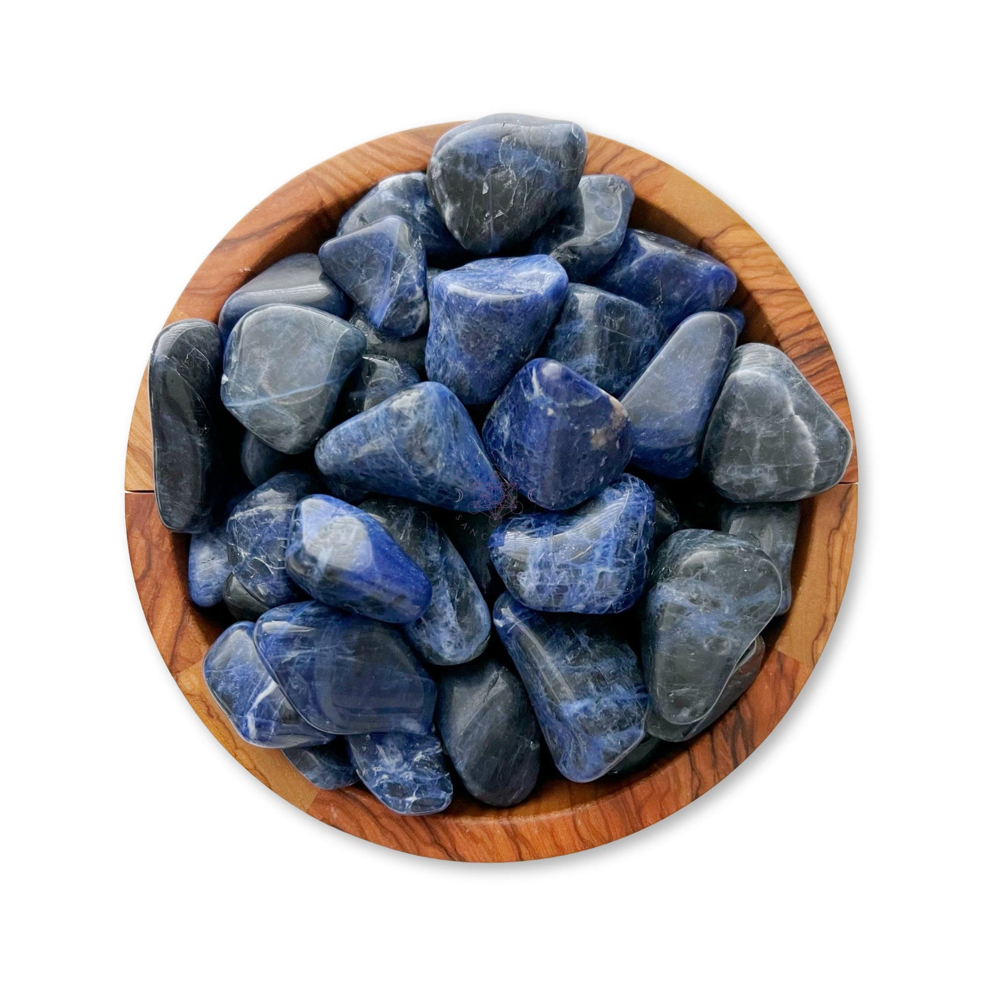 A wooden bowl filled with Sodalite Tumbled Stones. The stones are varying shades of blue, with white and gray veins, and have a smooth, glossy finish. The bowl has a natural wood grain pattern and a light brown color.