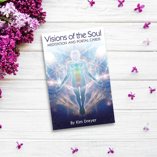 The product name is already correctly integrated into the sentence provided:

"A book titled "Visions of the Soul: Meditation and Portal Cards" by Kim Dreyer lies on a white wooden surface adorned with scattered purple flowers. The cover features an ethereal figure surrounded by colorful, mystical patterns—an exquisite oracle deck for spiritual seekers. Purple flowers are placed on the left.