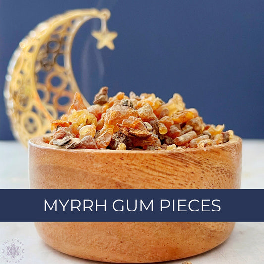 A wooden bowl filled with *Myrrh Gum Pieces* is placed on a light-colored surface. In the background, a decorative golden crescent moon with a hanging star is partially visible against a dark blue backdrop. The text "MYRRH GUM PIECES" is displayed in front, renowned for their purification properties.